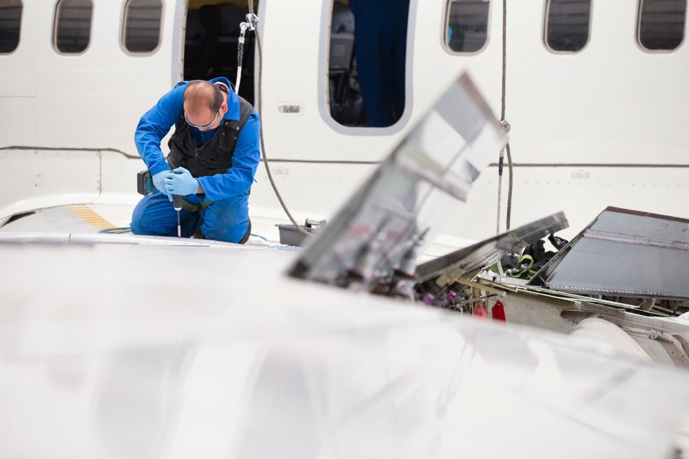 A man working on an airplane, an example of what it might look like around the implementation of P-2000